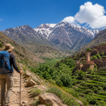 hiker trekking in the Atlas Mountains Morocco near Amizmiz with Berber village and mountain landscape