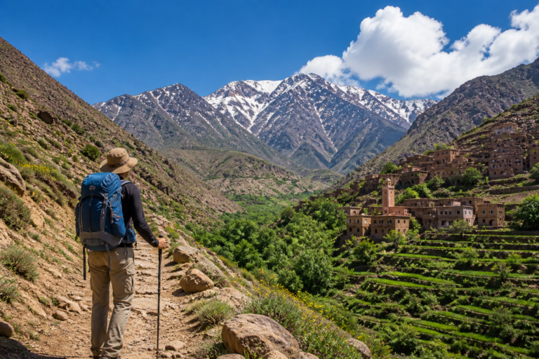hiker trekking in the Atlas Mountains Morocco near Amizmiz with Berber village and mountain landscape
